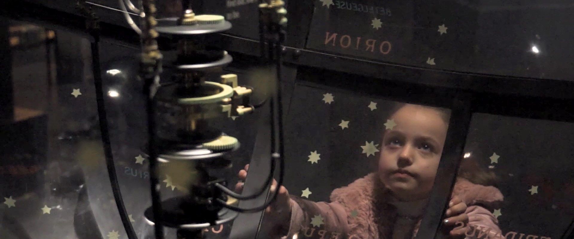 young girl fascinated by the orrery at national museums scotland www.completelynormalmedia.com