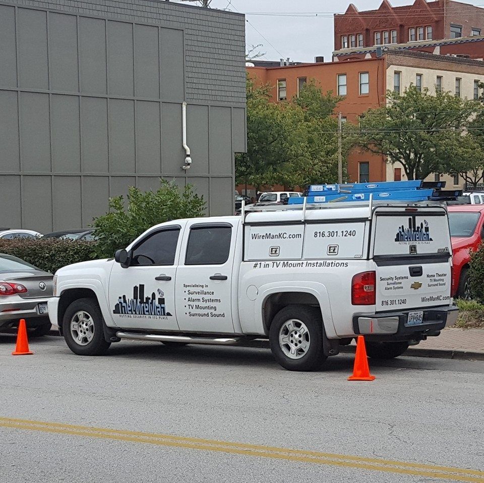 A white van with the word home security on the side