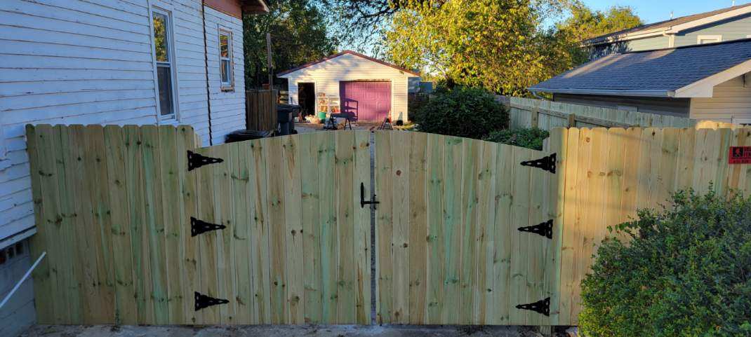 A wooden fence is sitting in front of a house. Clarksville, TN