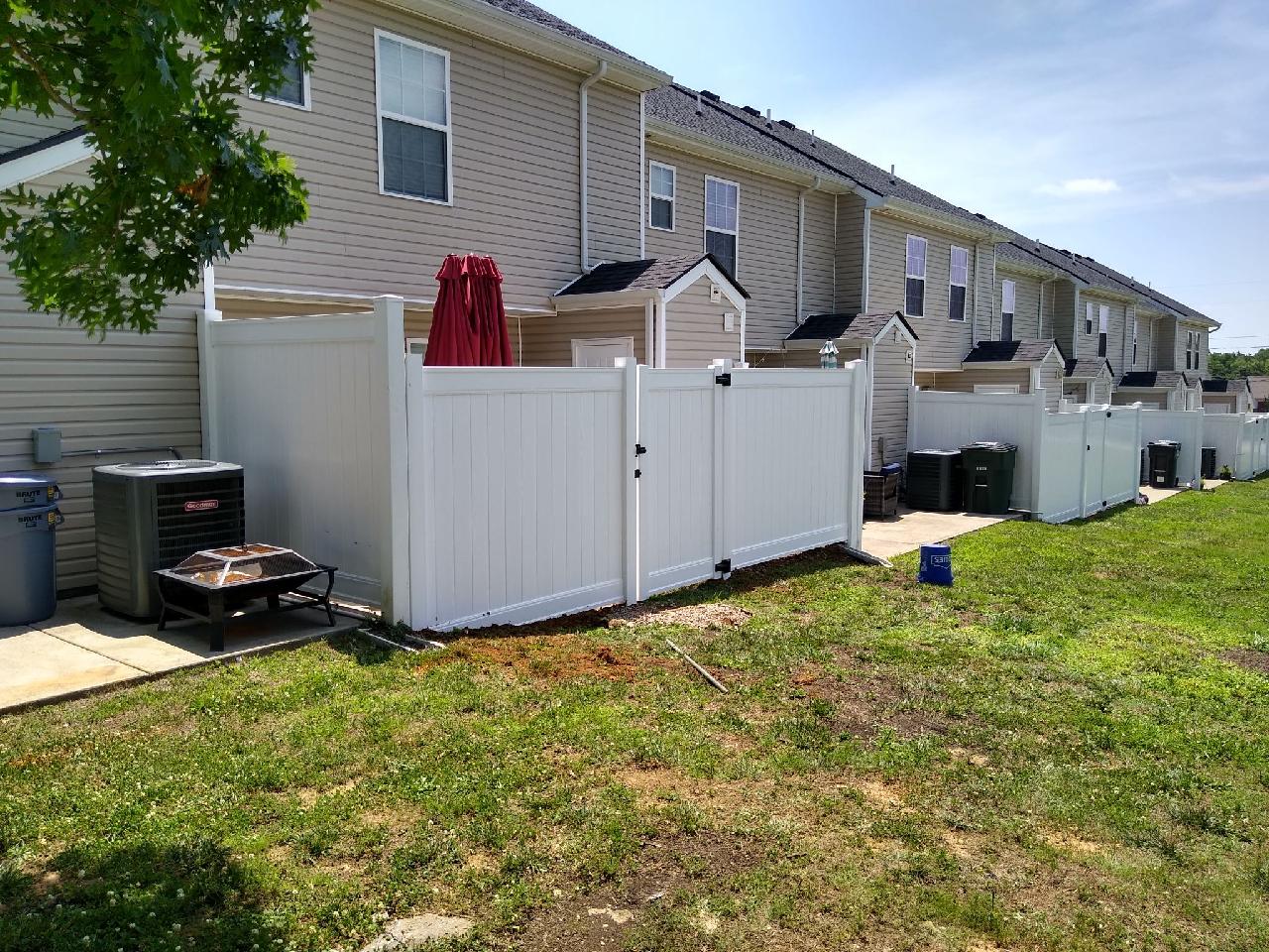 There is a white fence in the backyard of a house. Clarksville, TN