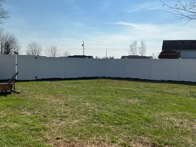 A backyard with a white fence and a swing. Clarksville, TN