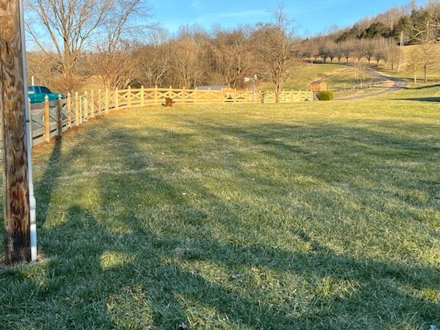A large grassy field with a wooden fence in the background. Clarksville, TN