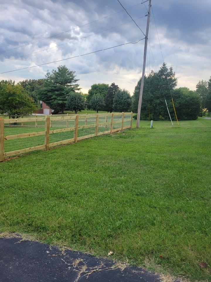 A wooden fence surrounds a lush green field. Clarksville, TN
