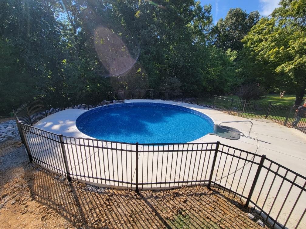 A large swimming pool surrounded by a fence and trees. Clarksville, TN