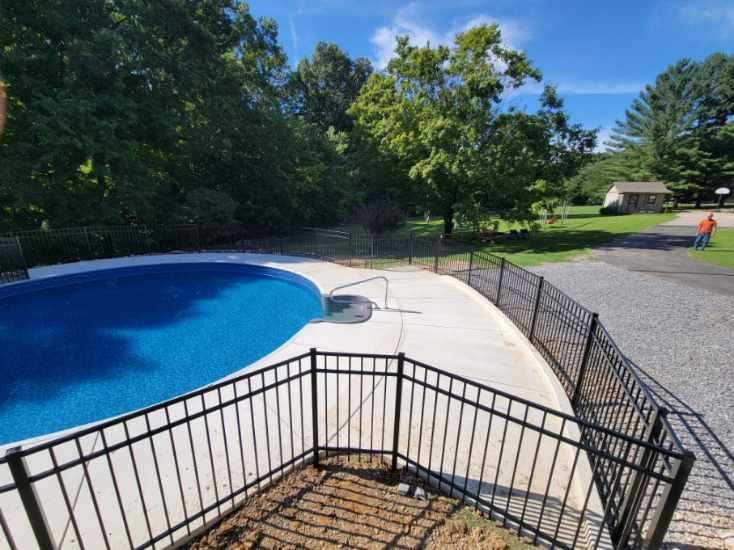 A swimming pool with a black fence around it Clarksville, TN