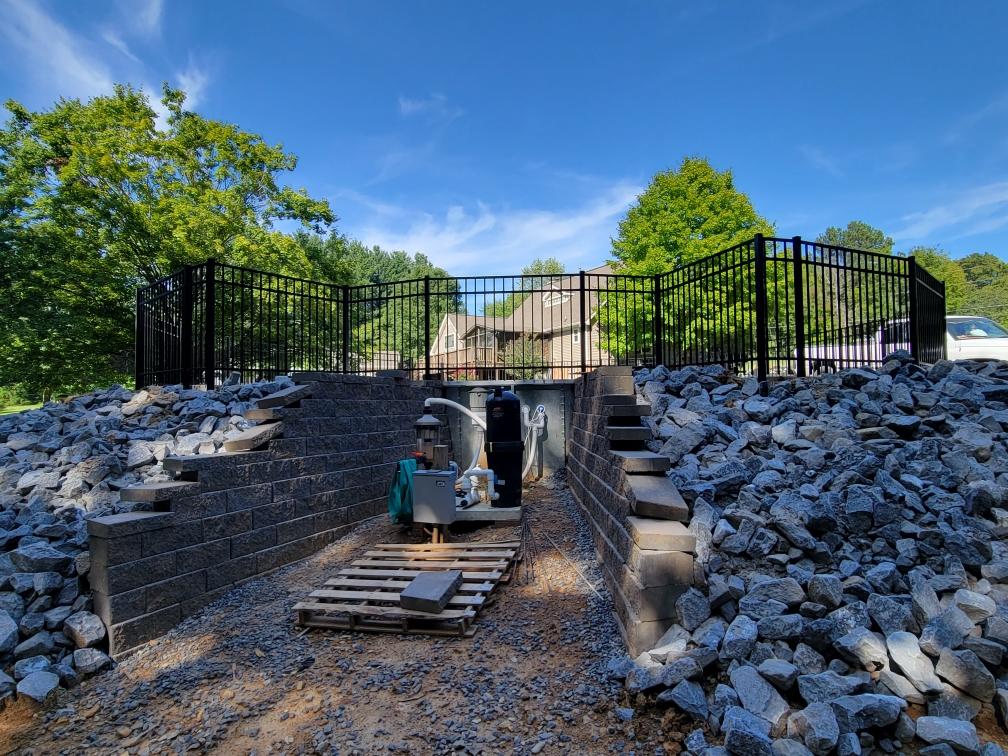 A pile of rocks is sitting on top of a pile of gravel next to a fence. Clarksville, TN