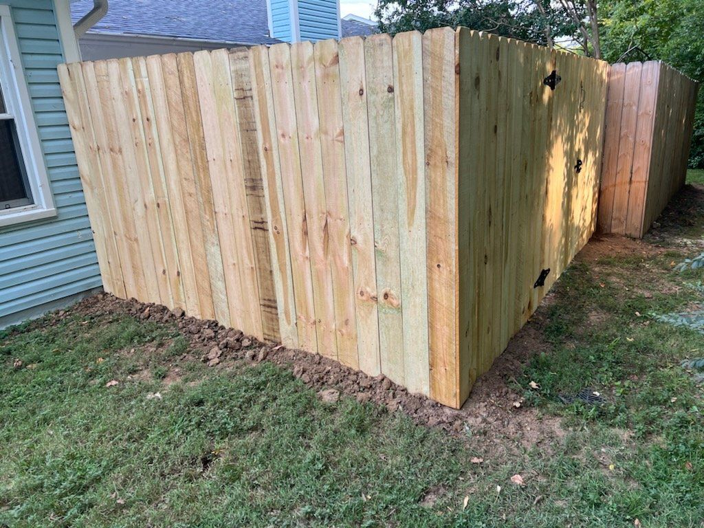 A wooden fence is sitting in the grass in front of a house. Clarksville, TN