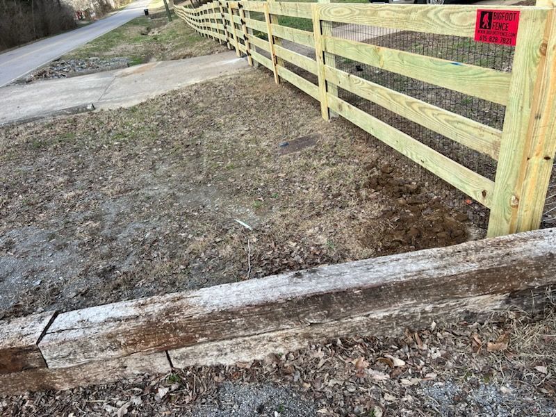 A wooden fence is sitting next to a wooden railroad track. Clarksville,TN