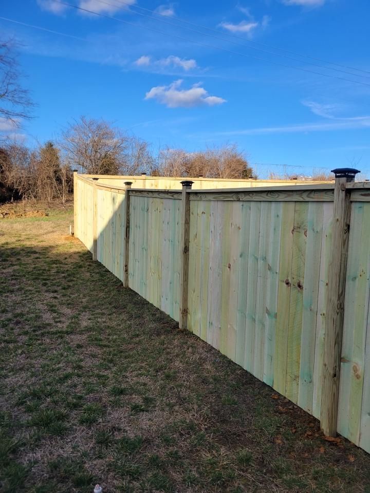 A wooden fence is sitting in the middle of a grassy field. Clarksville,TN