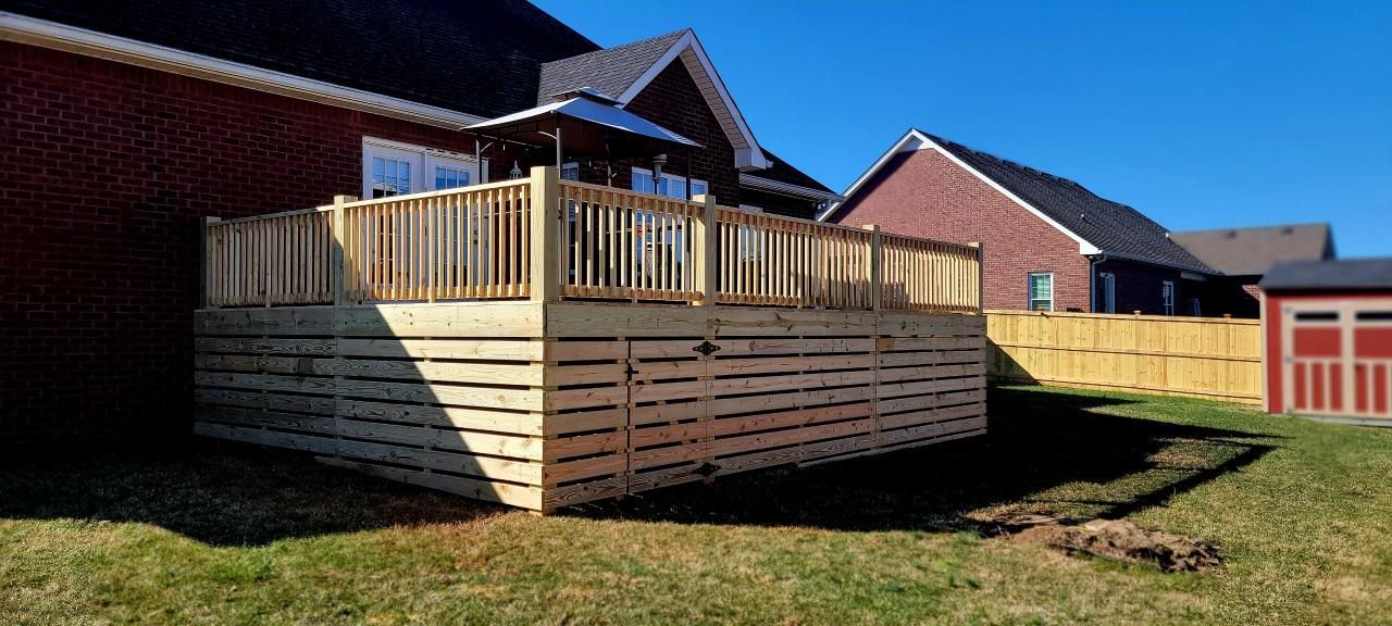 A large wooden deck is in the backyard of a house. Clarksville,TN