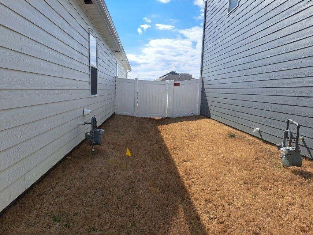 There is a white fence in the backyard of a house. Middle, TN