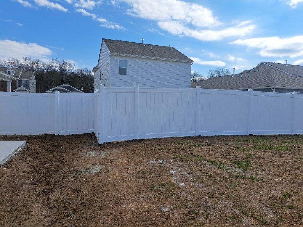 There is a white fence in the backyard of a house. Middle, TN