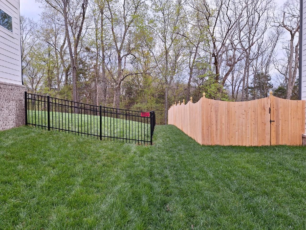 There is a wooden fence and a metal fence in the backyard. Middle, TN