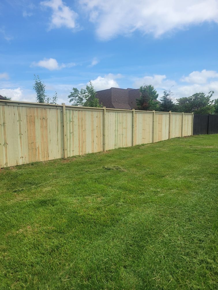 A wooden fence is in the middle of a lush green field. Clarksville,TN