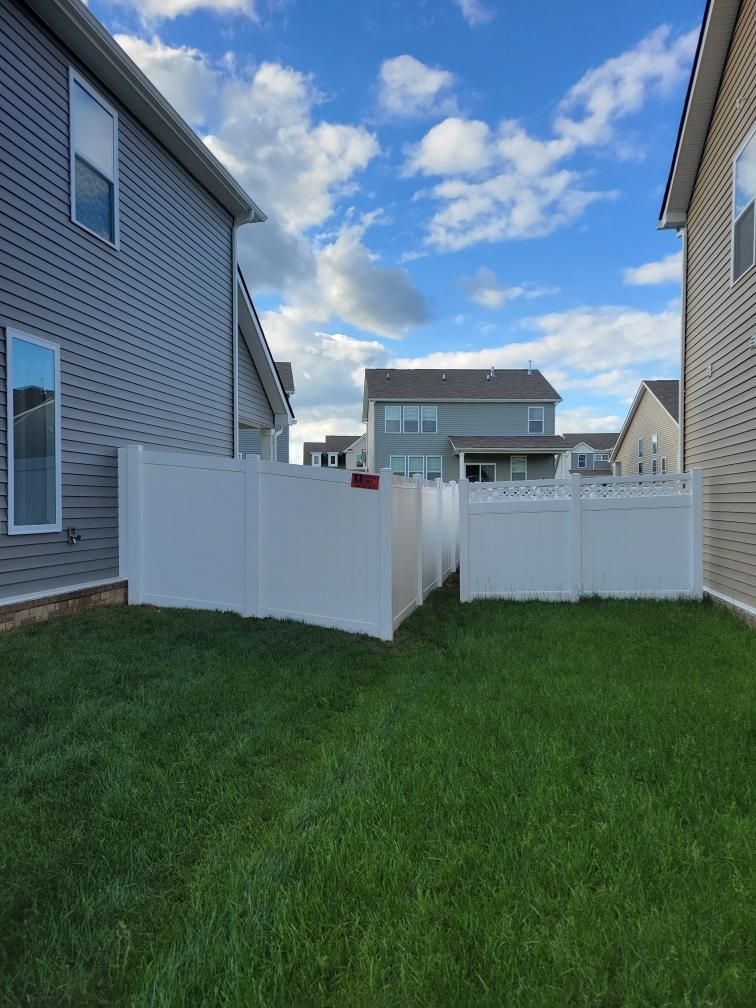 There is a white fence in the backyard of a house. Middle, TN