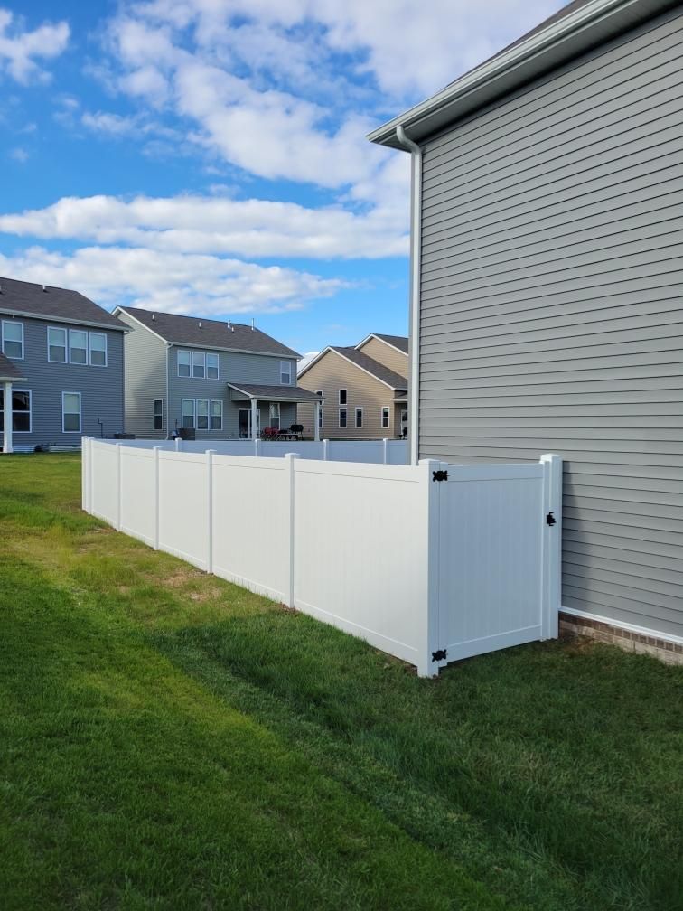 There is a white fence in the backyard of a house. Middle, TN
