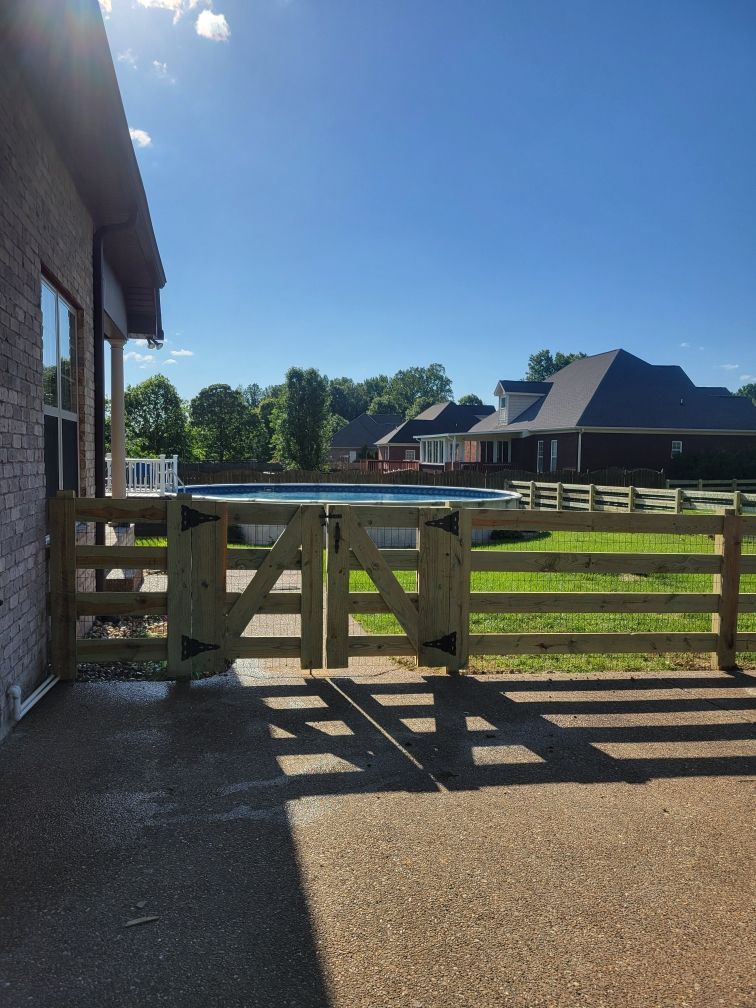 A wooden fence with a pool in the background. Clarksville,TN