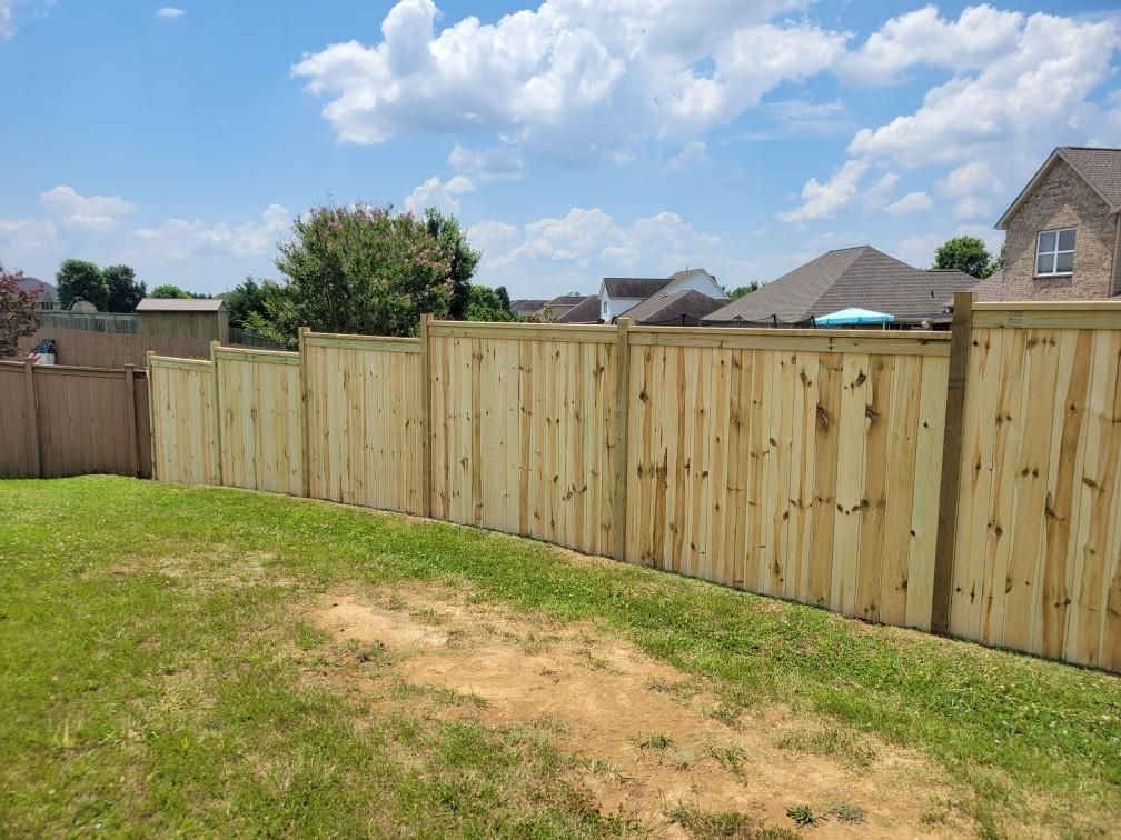 A wooden fence is in the backyard of a house. Clarksville, TN