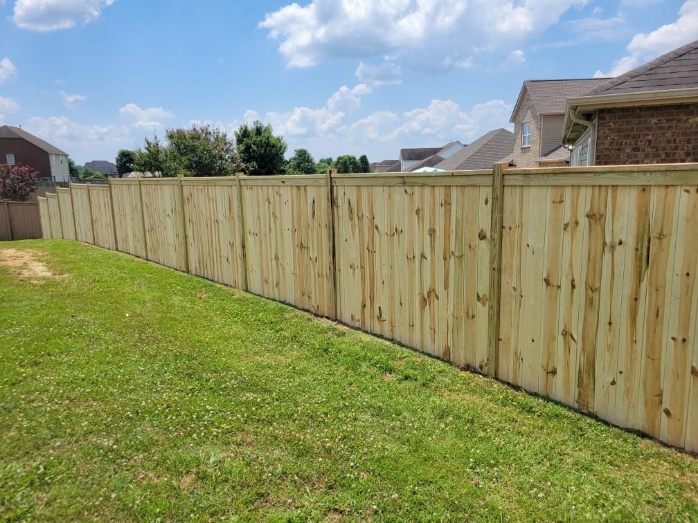 A wooden fence is sitting in the middle of a lush green field. Clarksville, TN