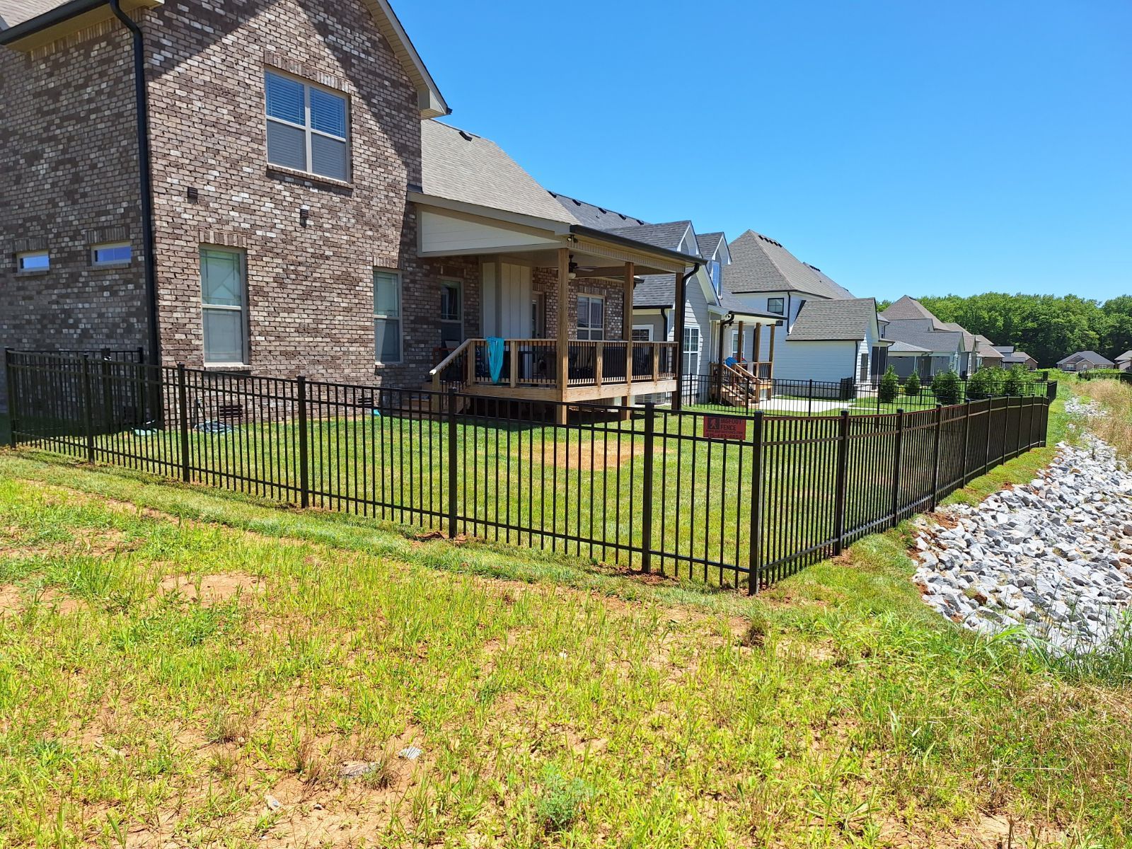 A house with a porch and a fence in front of it. Clarksville, TN