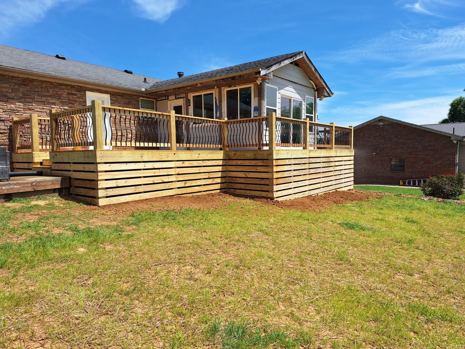 A wooden deck with stairs leading up to it. Middle, TN