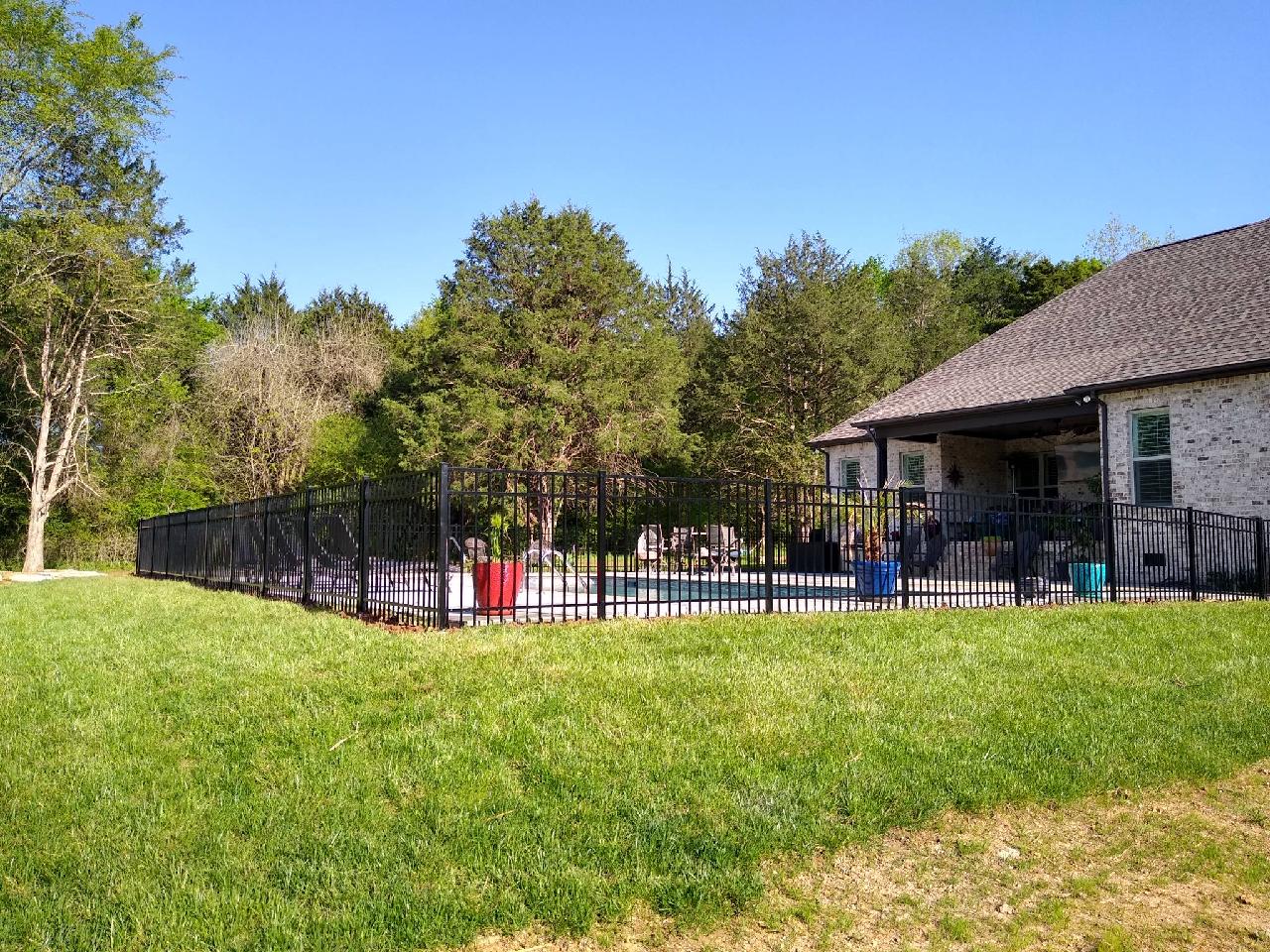 A house with a fence around it and a pool in the backyard. Middle, TN