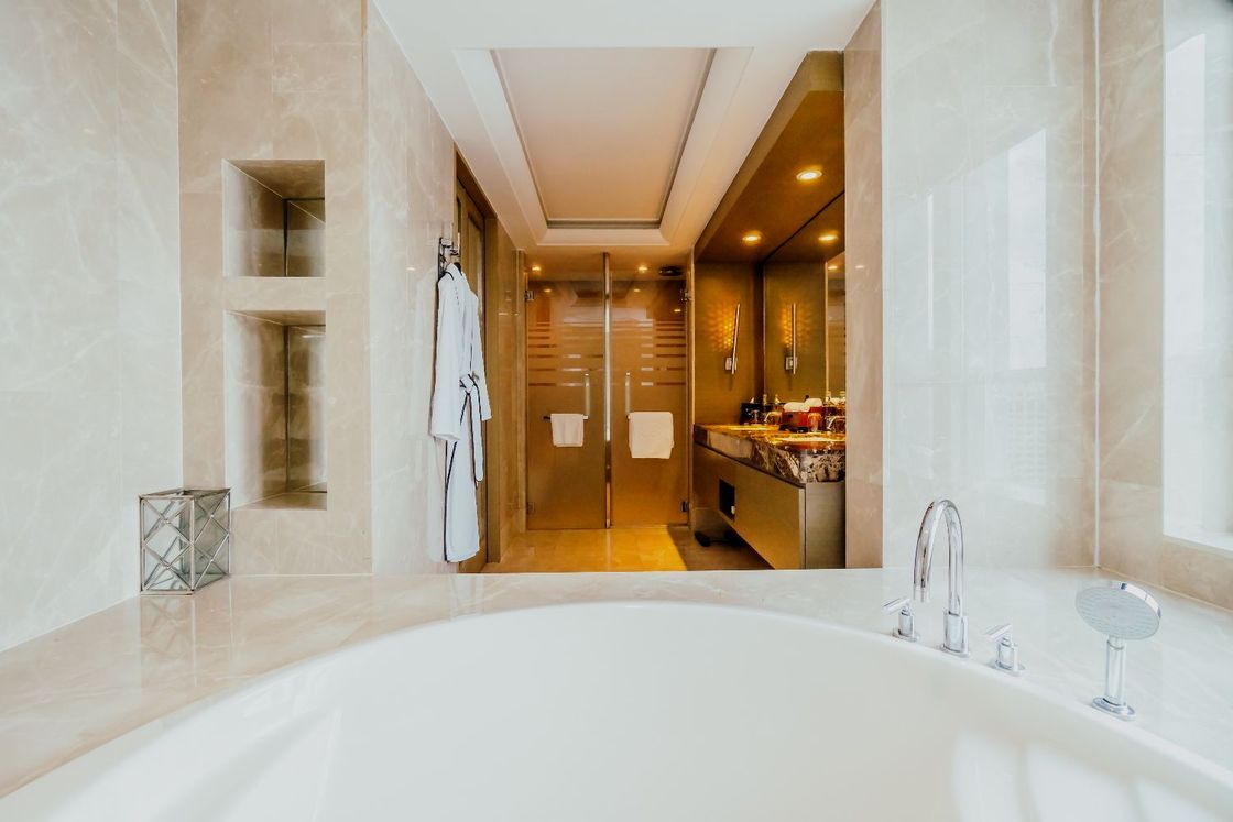 There is a large bathtub in the middle of the bathroom.