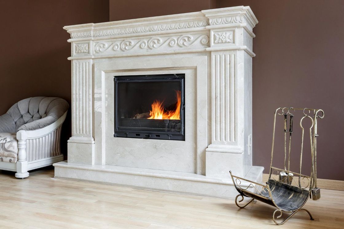 A living room with a fireplace and a chair.