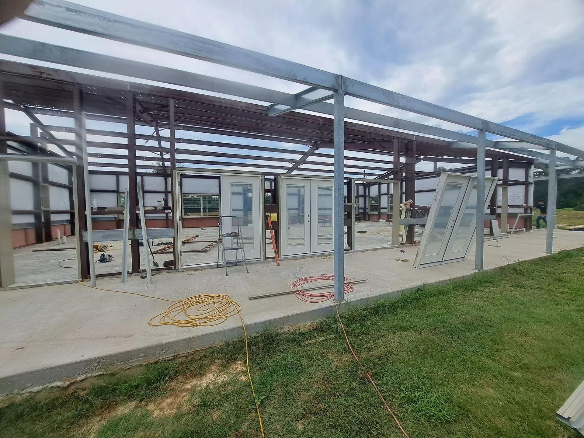 A building under construction with a lot of windows and doors.