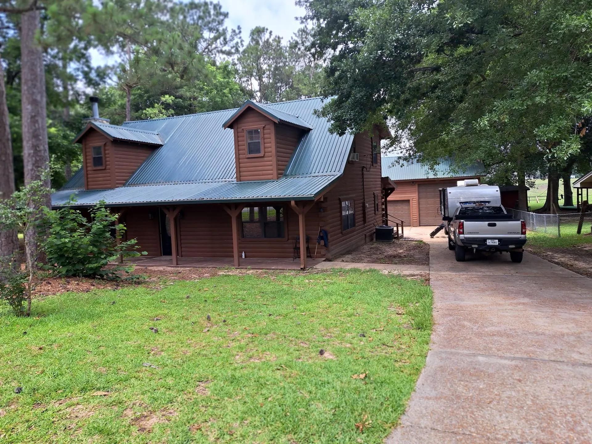 A house with a truck parked in front of it