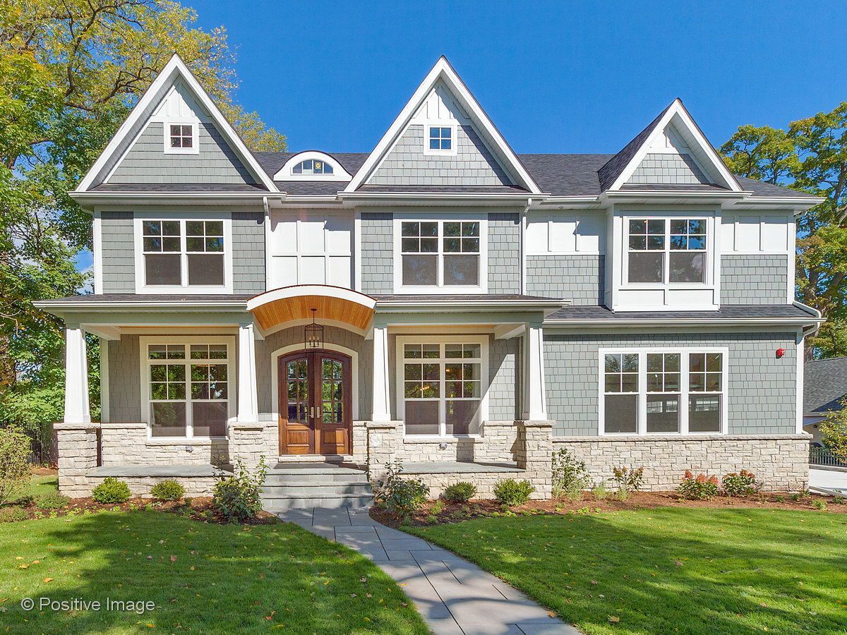 A large house with a lot of windows and a walkway leading to it.