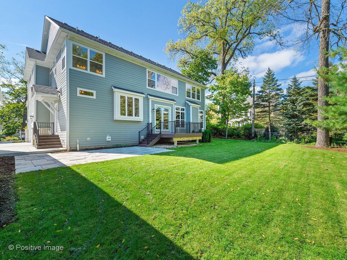 A large house with a large lawn in front of it.