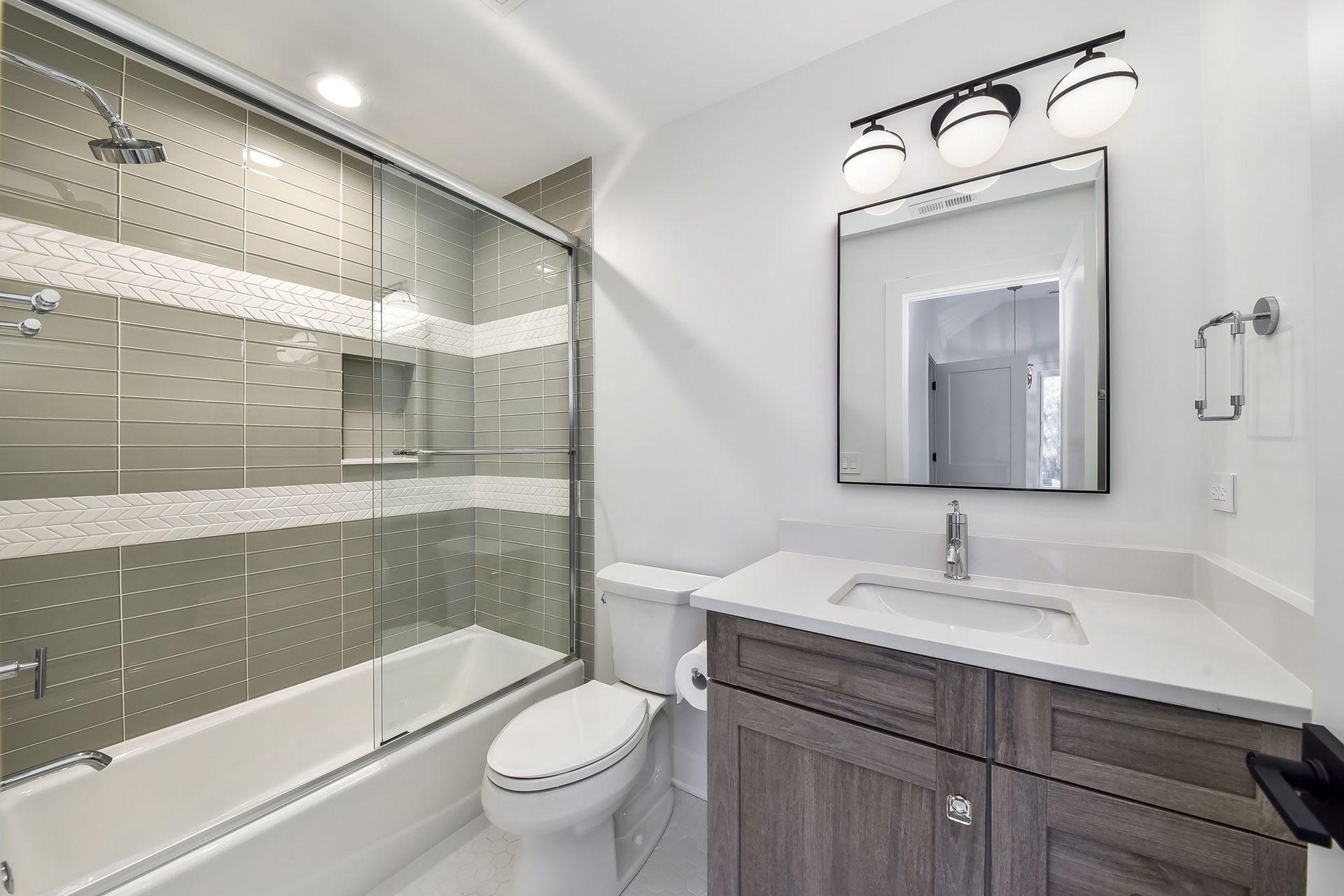 A bathroom with a toilet , sink , bathtub and shower.