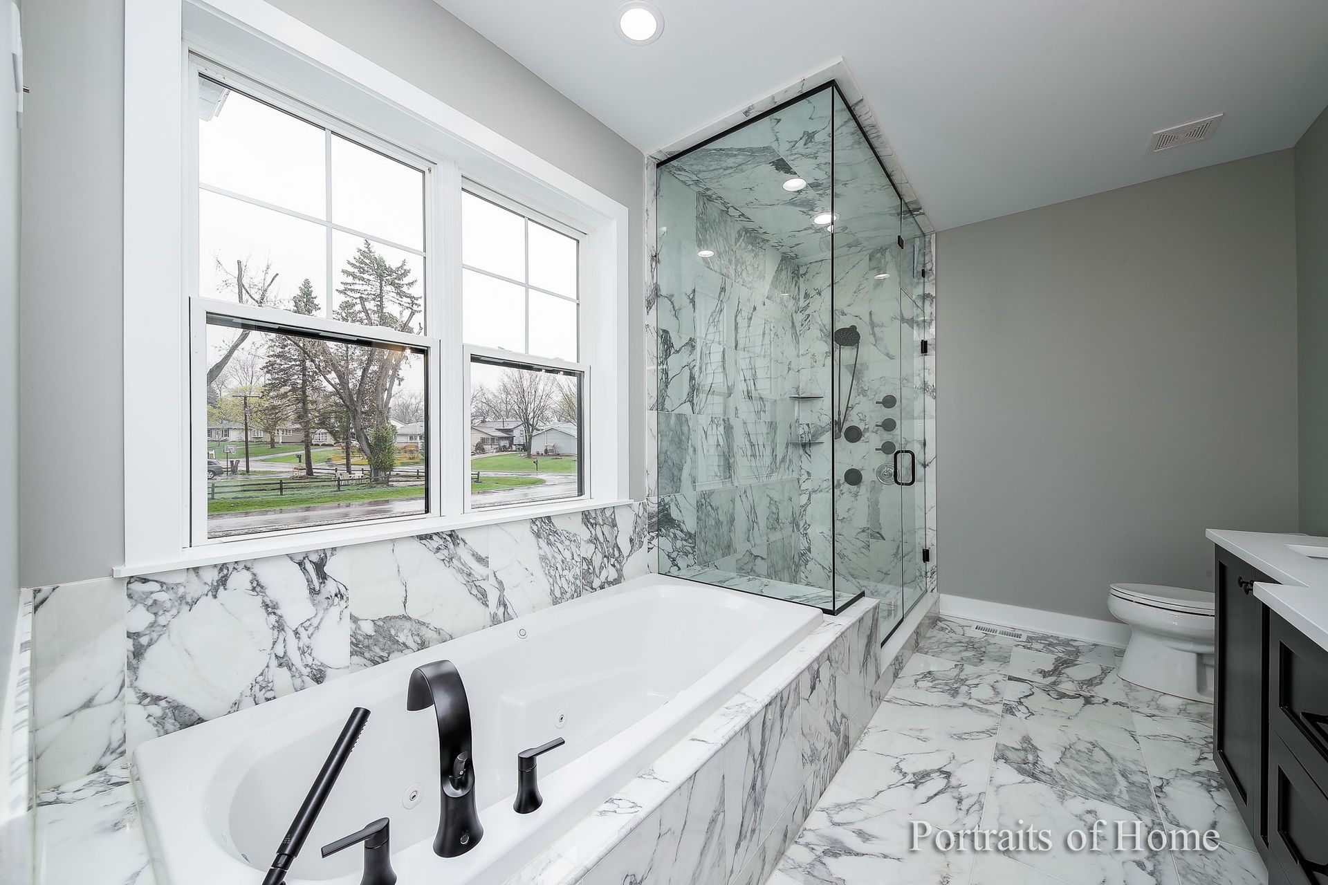 A bathroom with a bathtub and a walk in shower.
