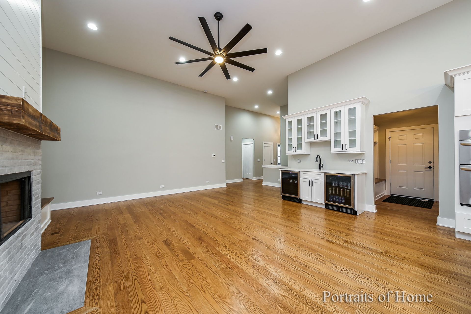 A living room with hardwood floors and a ceiling fan