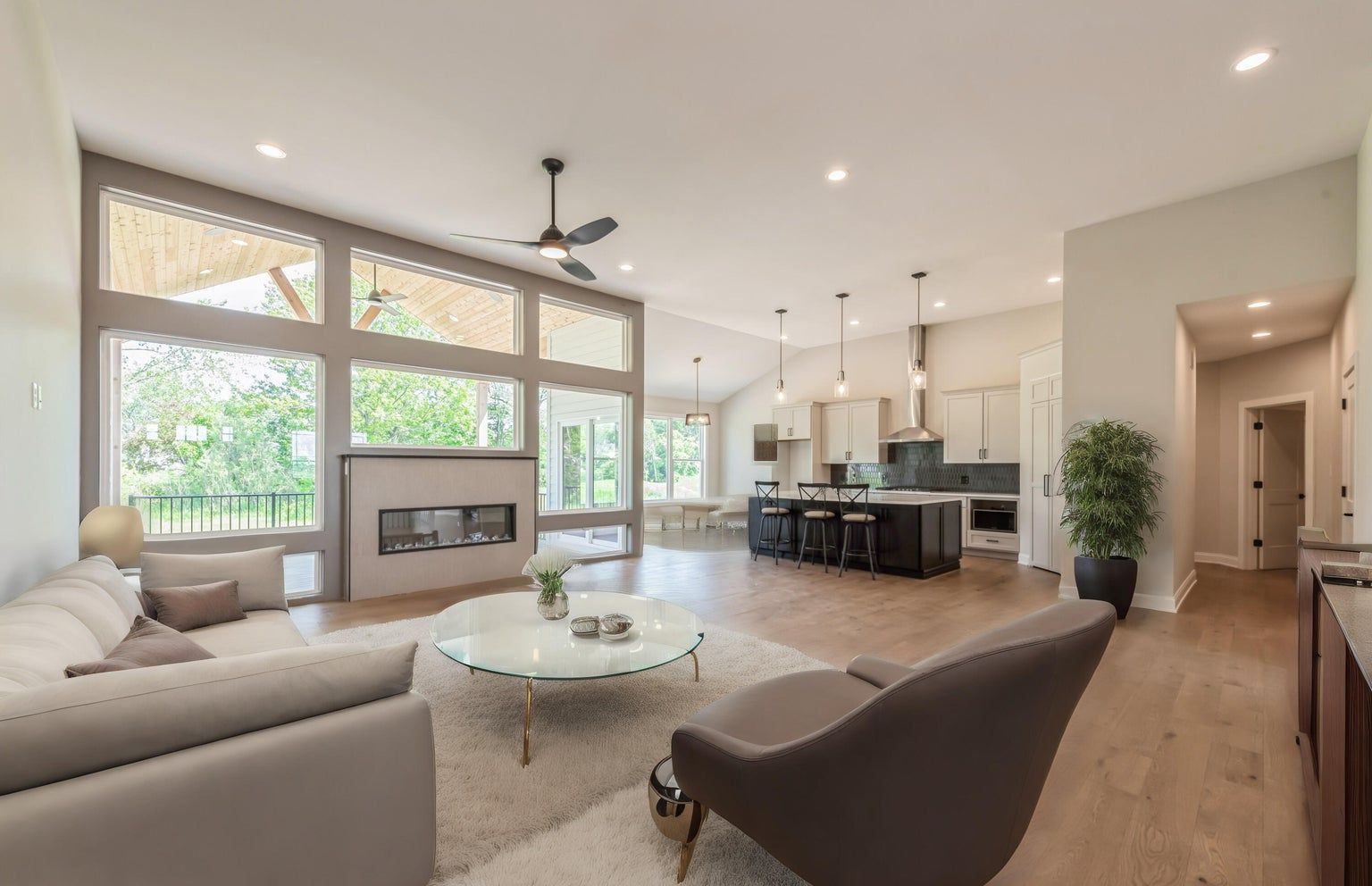 A living room with a couch , chair , coffee table and fireplace.