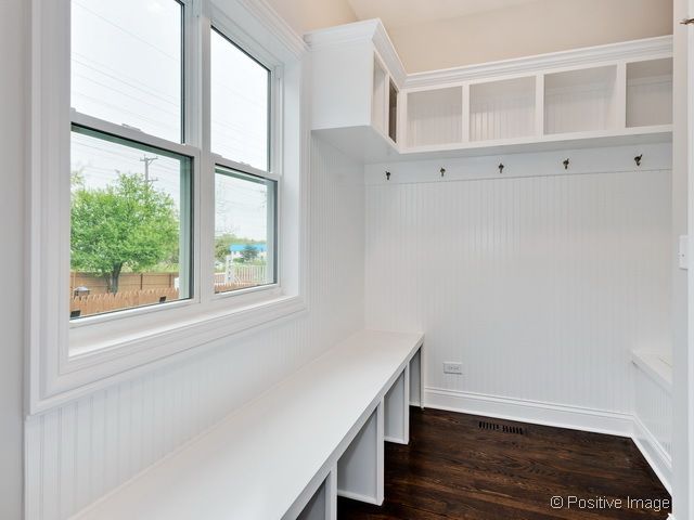 A white room with a window and a bench