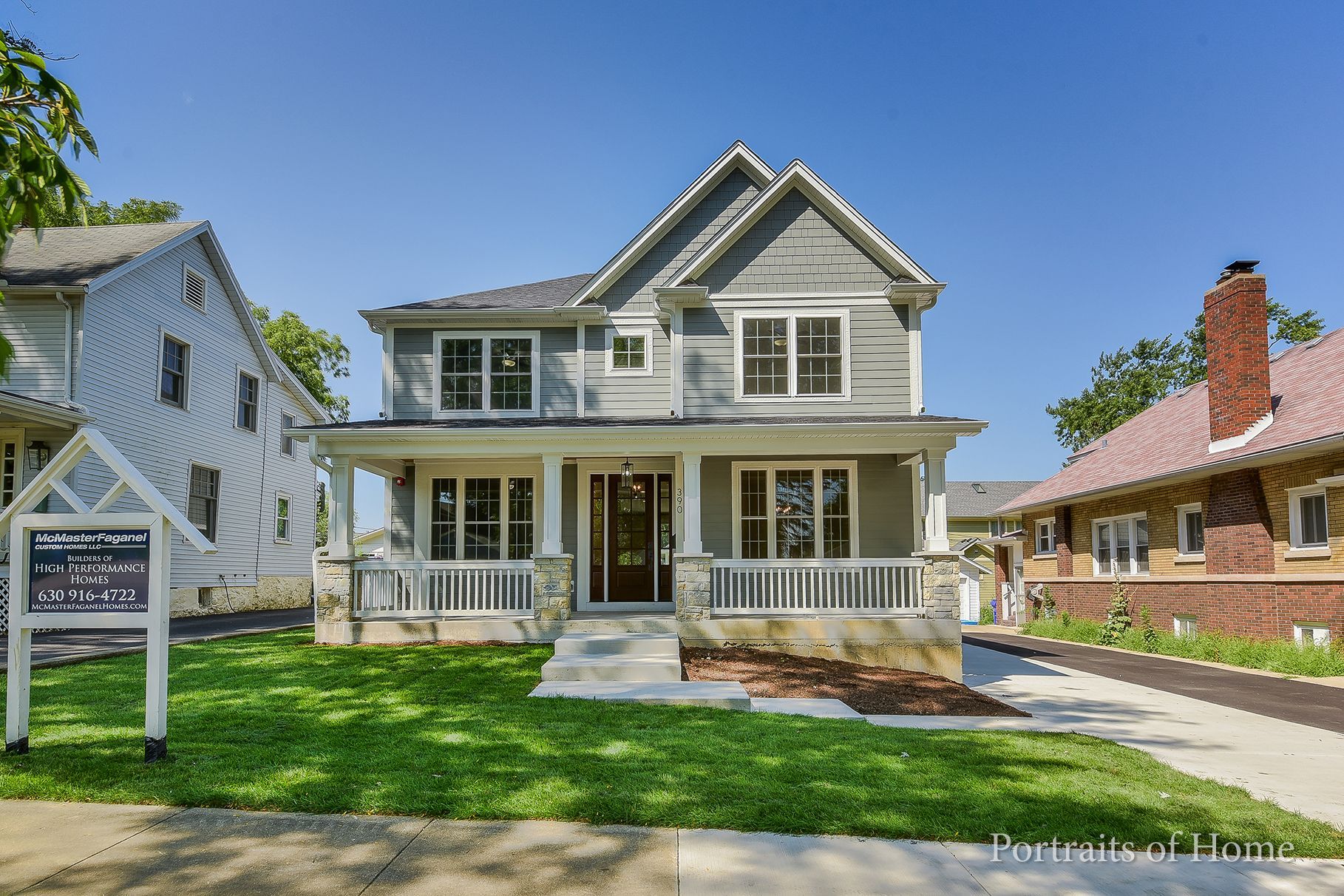 A large house with a large porch is for sale.