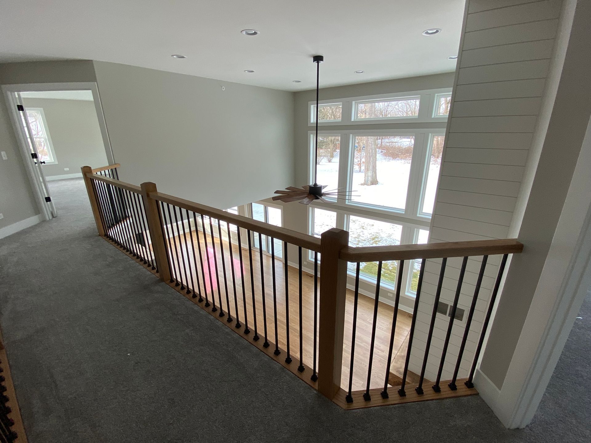 A view of a staircase from the second floor of a house.
