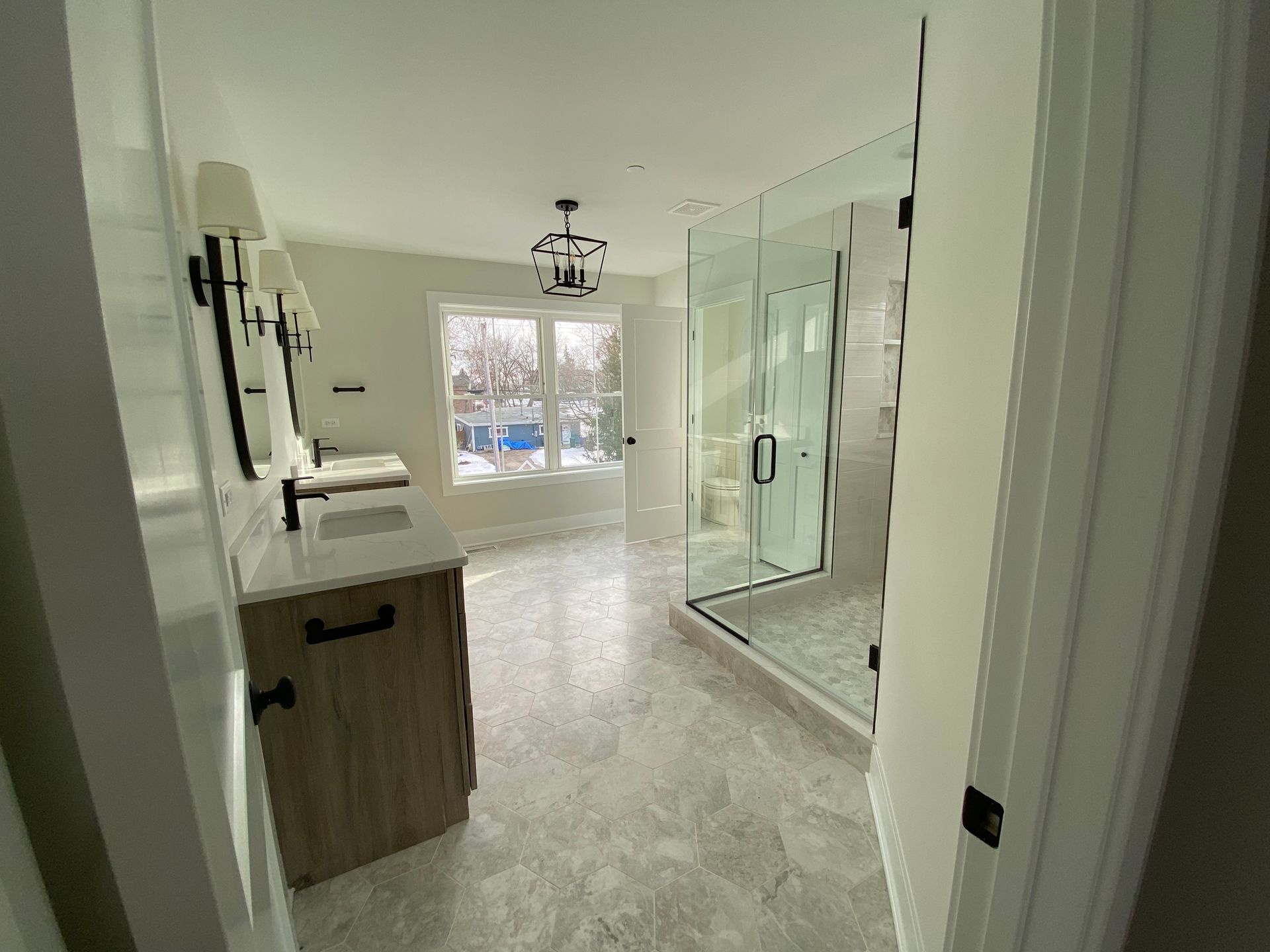 A bathroom with a sink and a walk in shower.