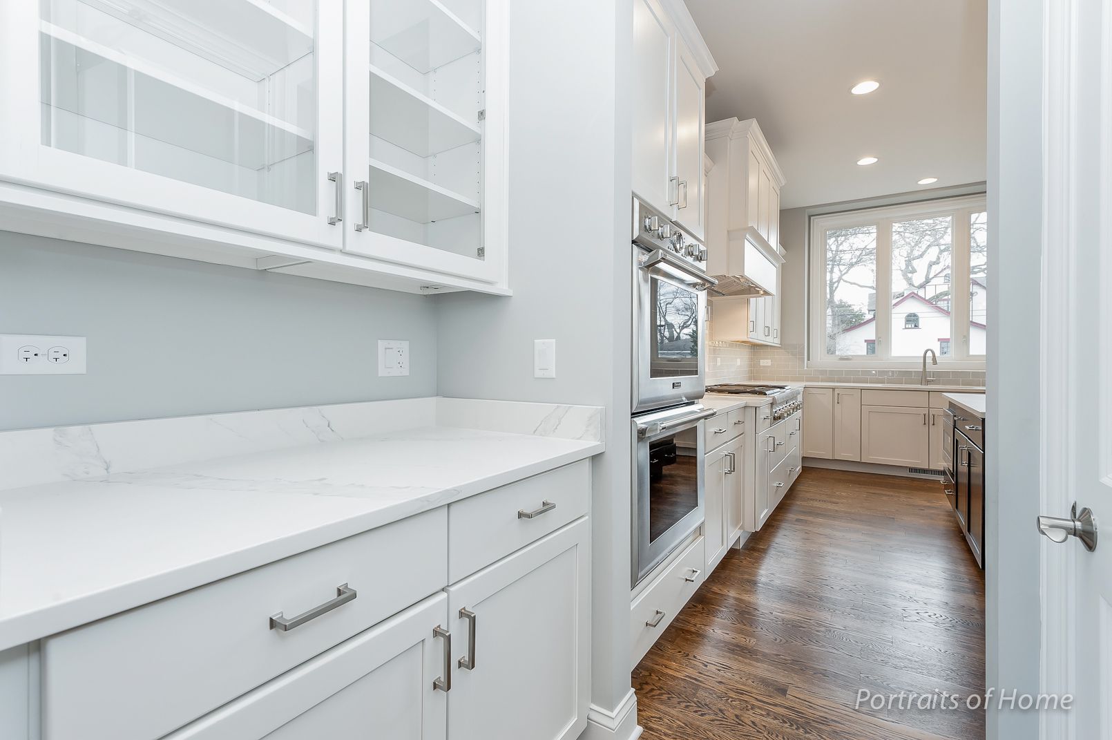 A kitchen with white cabinets and stainless steel appliances.