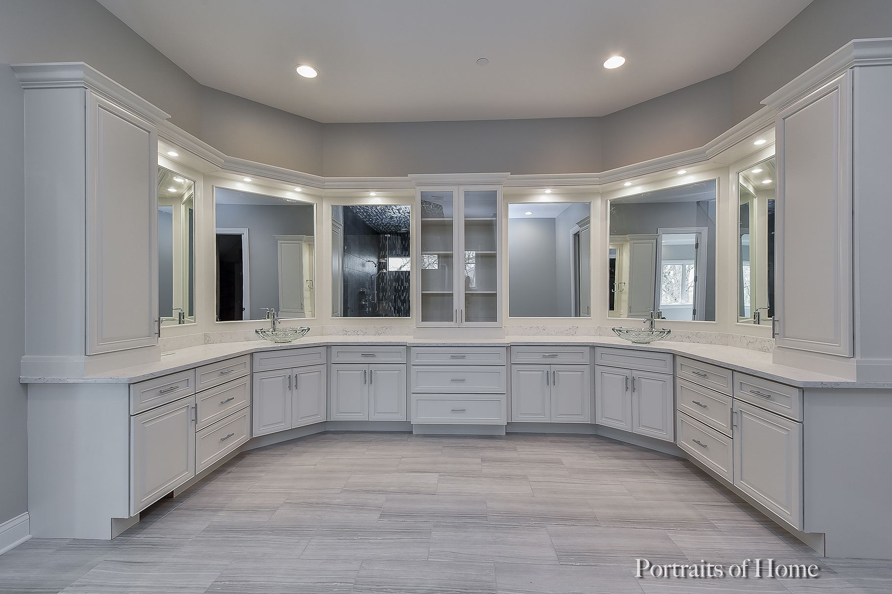 A large bathroom with a lot of cabinets and mirrors.