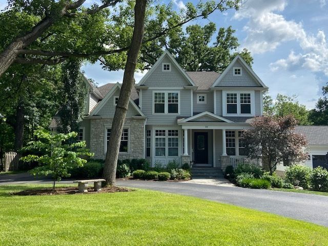 A large house with a tree in front of it