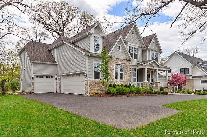 A large house with two garages and a driveway is for sale.
