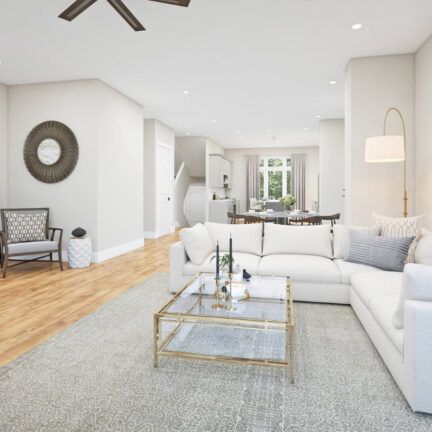 A living room with white furniture and a ceiling fan