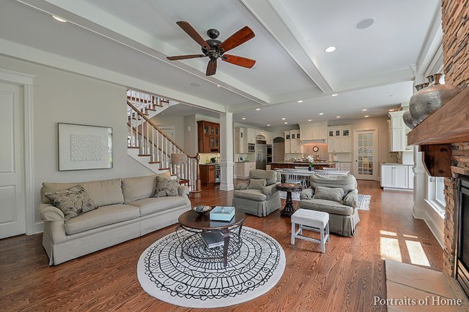 A living room filled with furniture and a ceiling fan.