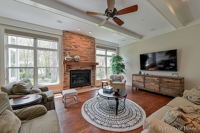 A living room with a fireplace and a flat screen tv.