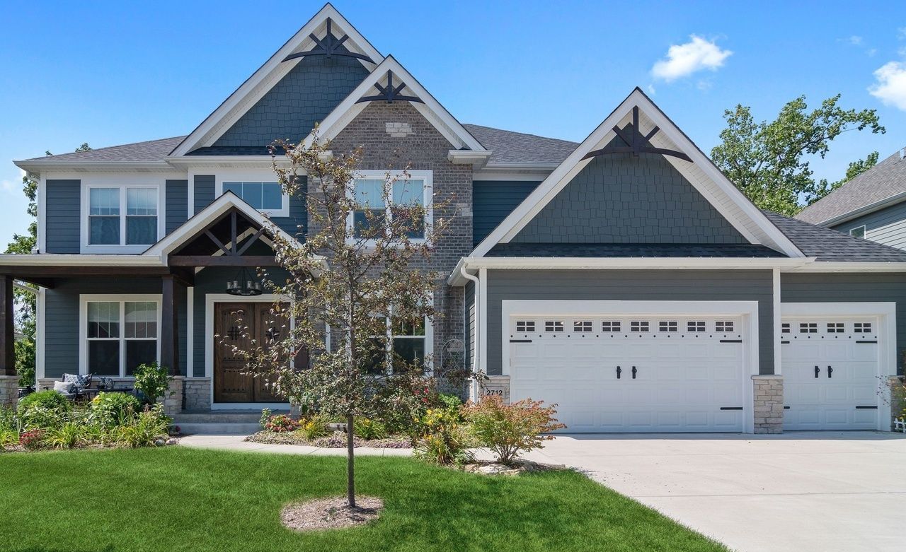 A large house with a lot of windows and a tree in front of it