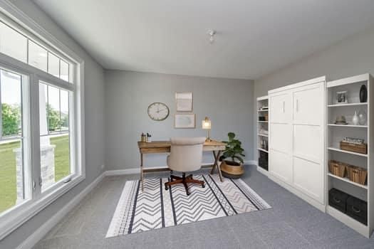 A room with a desk and a chair in it