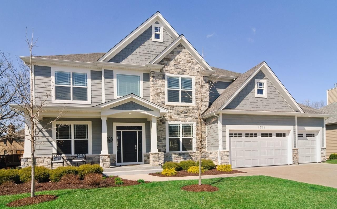 A large house with a lush green lawn in front of it.